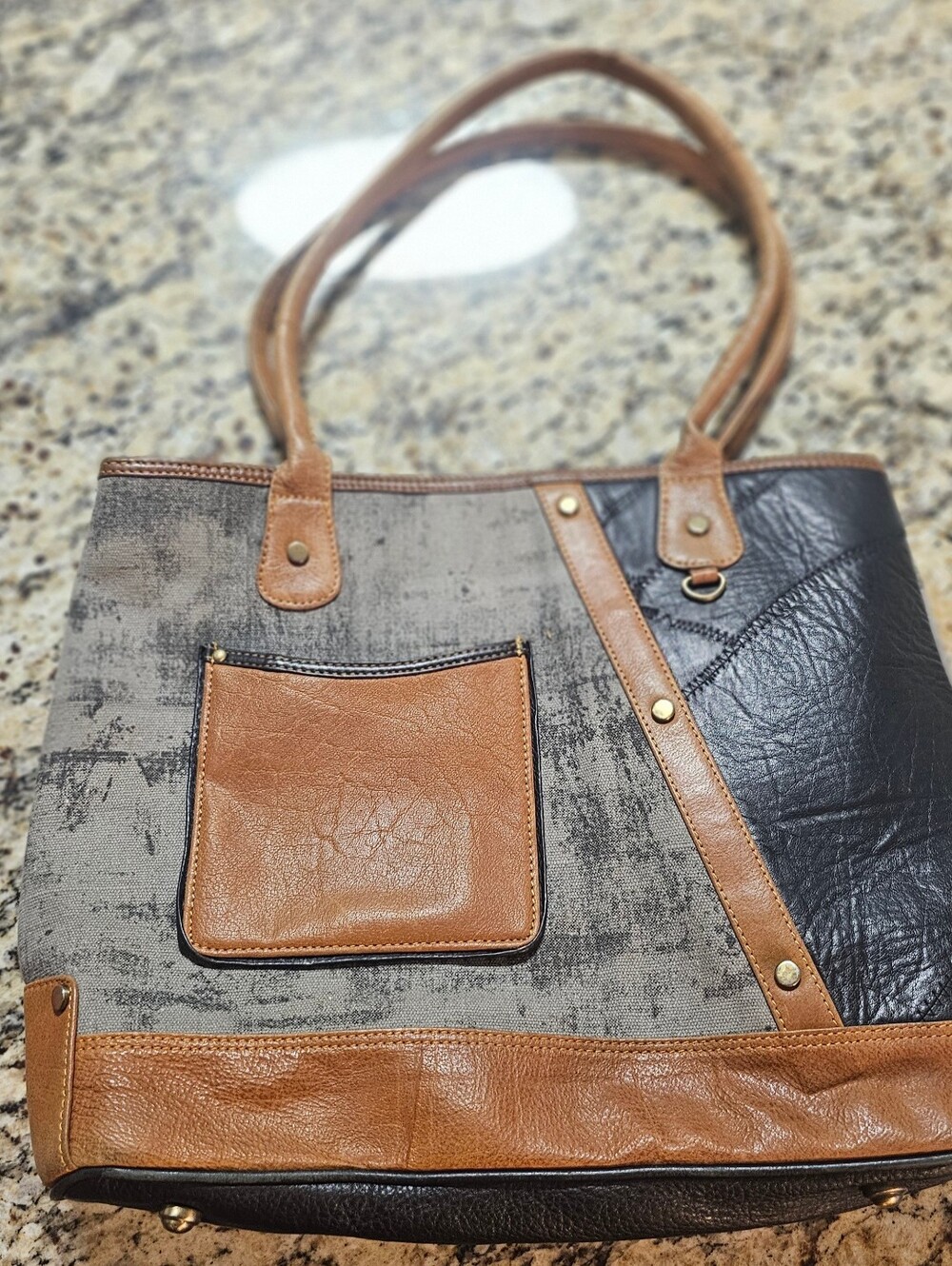 Vaan & Co Tessa Tote features a patchwork design of upcycled genuine leather